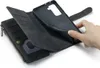 A hand is shown holding a black leather wallet-style phone case open, revealing card slots and a zippered compartment. The phone holder part of the case is also visible. Produktbild-Vorschau