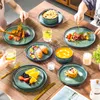 A table setting with multiple plates of food, drinks, and cutlery, suggesting a meal or dining experience. Voir les images du produit