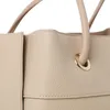 A close-up view of a beige handbag. Náhled obrázku produktu