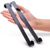 A hand holding two black door hooks against a white background. Produktbild-Vorschau