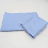 Two pieces of light blue fabric, likely bedding, laid out on a white surface. Produktbild-Vorschau