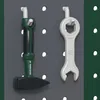A hammer and a wrench hanging on a pegboard. Produktbild-Vorschau