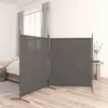 A room divider is set up in a bedroom, partially obscuring a bed. A small table with a vase of flowers is visible to the right. Voir les images du produit