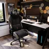 A gaming chair and desk setup in a modern room. Náhľad obrázku produktu