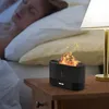 A person sleeping in bed next to a bedside table with a black aroma diffuser emitting a flame-like mist. Voir les images du produit