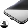 A close-up shot of the bottom corner of a smartphone, showing the charging port and a small cleaning tool. Voir les images du produit