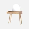 A light wood dressing table with a rounded mirror and two drawers, one of which is open. Produktbild-Vorschau