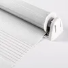 A close-up view of a white roller blind mechanism and fabric. Produktbild-Vorschau