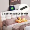 A bed with a headboard featuring integrated USB ports and LED lighting. Produktbild-Vorschau