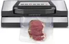 A vacuum sealer with a piece of raw meat in a plastic bag in front of it. Anteprima dell’immagine prodotto
