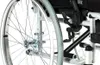 A close-up view of the rear wheel and frame of a wheelchair. Produktbild-Vorschau