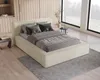 A modern bedroom with a beige upholstered bed, dressed in gray bedding and pillows, set against a backdrop of light wood paneling and large windows overlooking a natural landscape. Voir les images du produit