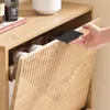 A hand is opening a wooden shoe cabinet, revealing shoes inside. Podgląd zdjęcia produktu