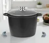 A black pot with a glass lid sits on a white table. Anteprima dell’immagine prodotto