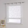 A white sheer Roman blind with a damask pattern hangs over a window. A framed picture and a candle are on the windowsill. Produktbild-Vorschau