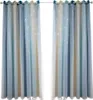 Two blue, white, and beige gradient curtains with small white stars are hanging from a curtain rod. Voir les images du produit