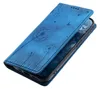A blue flip phone case with a dandelion design is shown from a diagonal angle. Produktbild-Vorschau