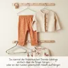 Children's clothes hanging on a rack. Anteprima dell’immagine prodotto