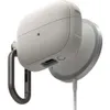 A close-up shot of a protective case for wireless earbuds, attached to a magnetic charging base. Produktbild-Vorschau