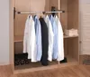 Inside a wardrobe, showing a clothes rail with shirts and a suit jacket hanging on it. Náhled obrázku produktu