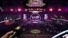 A dimly lit indoor entertainment venue with neon lights and a stage. Náhled obrázku produktu