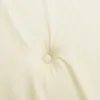 A close-up view of a tufted cushion or mattress pad with a single button in the center. Produktbild-Vorschau