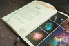An open book displaying text and images of nebulae. Produktbild-Vorschau