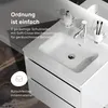 A close-up view of a white bathroom vanity with a sink, faucet, soap dispenser, and toothbrush holder. Text overlays describe product features. Produktbild-Vorschau