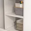 A close-up view of shelves in a white bookcase, showing storage items. Náhled obrázku produktu