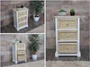 A collage of images showing a white and natural wood bedside table with rattan drawers, decorated with small potted plants and a large potted plant. Anteprima dell’immagine prodotto