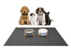 Four pets (two dogs, one kitten, one black cat) are sitting behind a pet feeding mat with two pet bowls on it. Produktbild-Vorschau