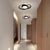 A modern hallway with two ceiling lights, wooden cabinets, and a decorative artwork. Produktbild-Vorschau
