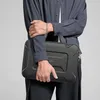 A person is holding a black laptop bag. Náhled obrázku produktu