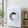 A white washing machine with a pillow inside, next to a plant and a shelf with a bottle and basket. Produktbild-Vorschau