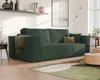 A dark green corduroy sofa in a living room setting, with a throw blanket draped over one arm and decorative pillows on the cushions. A round coffee table with a light wood finish is in the foreground, and a rug with geometric green and brown patterns is o Voir les images du produit