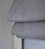 A close-up view of folded gray fabric, likely a window blind. Produktbild-Vorschau
