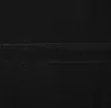 A close-up view of a black fabric surface with a strip of black velcro. Podgląd zdjęcia produktu