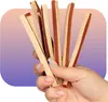 A hand holding several dog treats. Produktbild-Vorschau