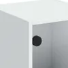 A close-up view of a white cabinet with a black circular knob or stopper on the inside wall of an open compartment. Produktbild-Vorschau
