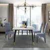 A dining room scene with a marble-topped table and four blue upholstered chairs, set against a large window with a city view. Produktbild-Vorschau