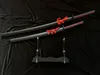 Two decorative katanas and wakizashis are displayed on a black velvet cloth with a black stand. Voir les images du produit