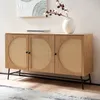 A wooden sideboard with rattan woven doors sits against a wall with artwork above it. Produktbild-Vorschau