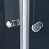 A close-up view of two chrome handles on a dark surface, likely a shower door. Produktbild-Vorschau