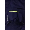 A close-up view of a navy blue work pant pocket with a neon yellow zipper and reflective detailing. Produktbild-Vorschau