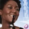 A woman is brushing her teeth with an electric toothbrush. Anteprima dell’immagine prodotto