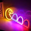 A neon sign shaped like Pac-Man and ghosts, lit up in various colors and casting reflections. Voir les images du produit