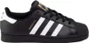 A studio shot of a black Adidas Superstar sneaker. Voir les images du produit
