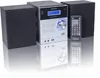 A stereo system with two speakers and a remote control, displayed on a reflective white surface. Produktbild-Vorschau