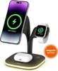 A black and silver 5-in-1 wireless charging station is shown with a smartphone, smartwatch, and earbuds charging on it. The charging station has a subtle yellow light around its base. Produktbild-Vorschau