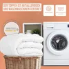 A folded white topper is shown in a wicker basket next to a washing machine, with marketing text and icons above. Produktbild-Vorschau